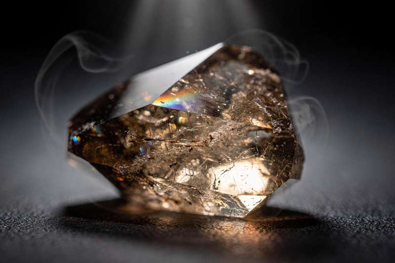 Cristal de cuarzo ahumado pulido con tonalidad marrón oscura destacando su capacidad para anclar energía y brindar protección...